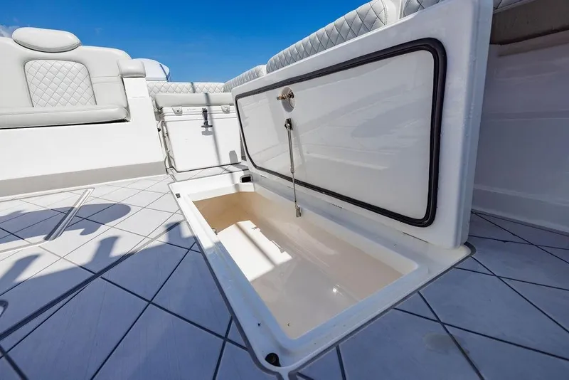 Slide: The Image of Open storage compartment on 2023 HCB 53 Suenos boat deck, featuring luxurious seating. - 26