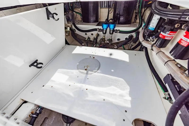 Slide: The Image of Engine compartment of 2023 HCB 53 Suenos boat, showcasing mechanical components and wiring. - 30