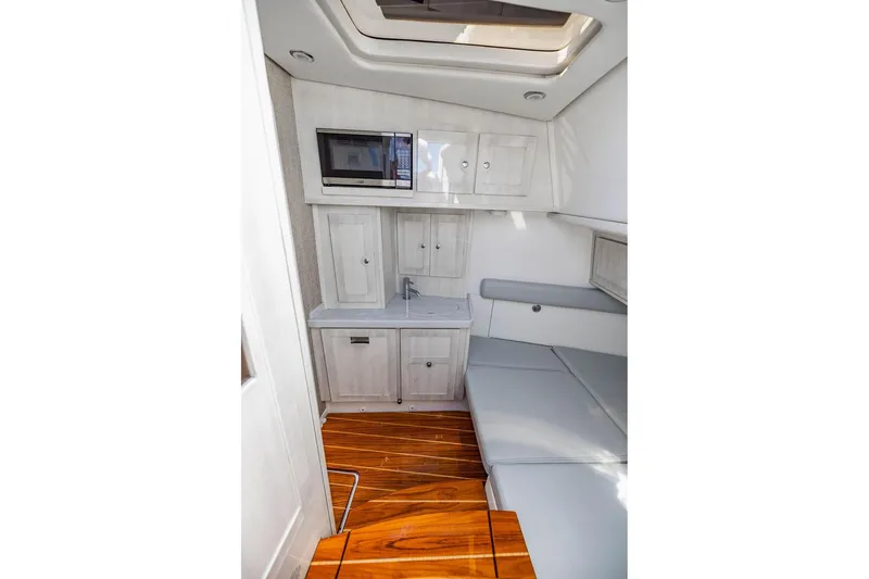 Slide: The Image of Interior of 2023 HCB 53 Suenos boat with kitchenette and seating area. - 44