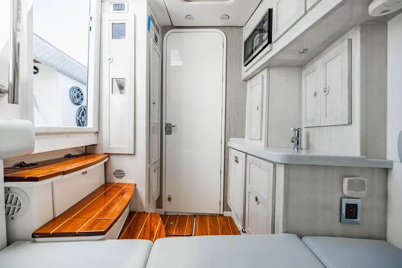 Slide: The Image of Interior of 2023 HCB 53 Suenos boat with modern cabinetry and wooden steps. - 45