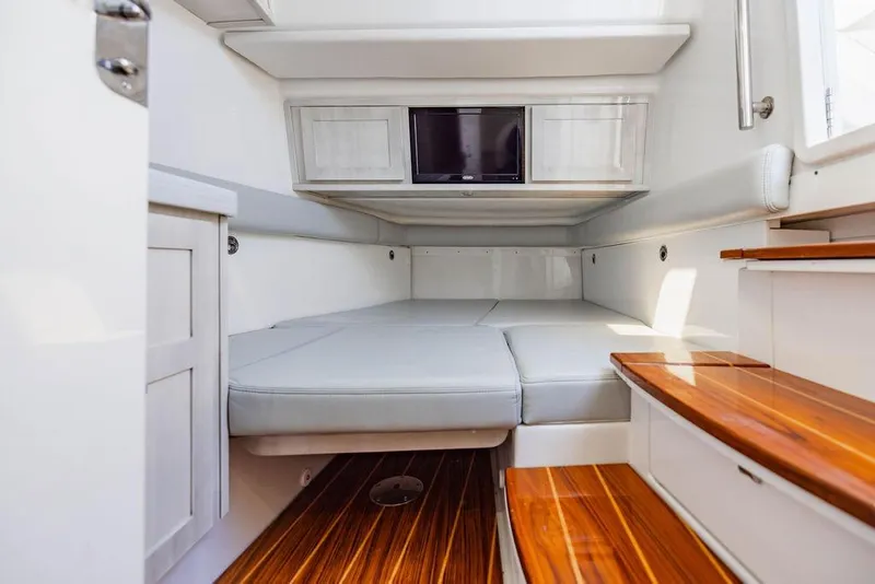 Slide: The Image of Interior cabin of 2023 HCB 53 Suenos boat with wooden steps and cushioned seating. - 46