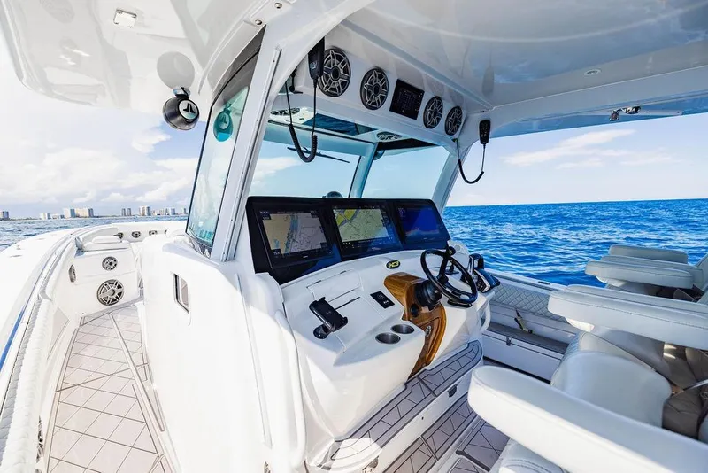 Slide: The Image of 2023 HCB 53 Suenos boat cockpit with advanced navigation systems on open sea. - 67