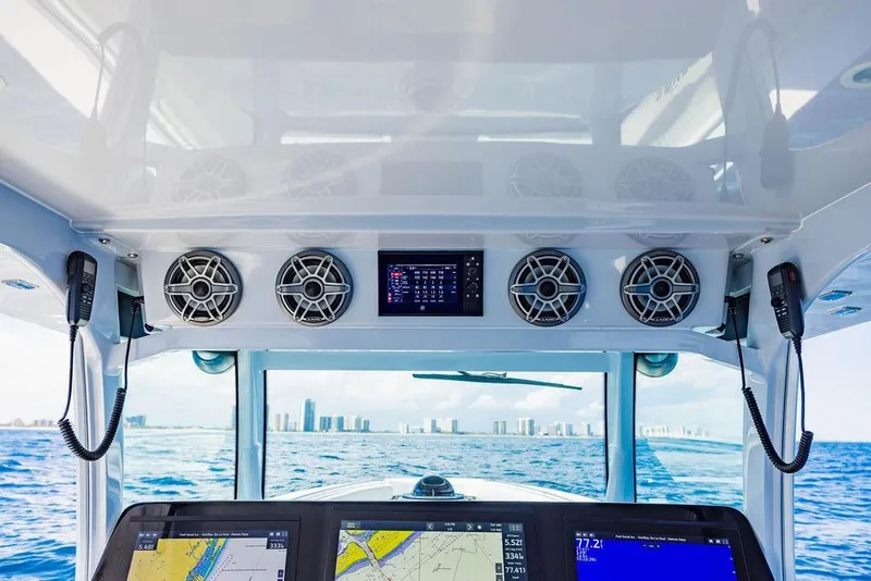 Slide: The Image of Interior view of 2023 HCB 53 Suenos boat cockpit with navigation screens and speakers. - 68