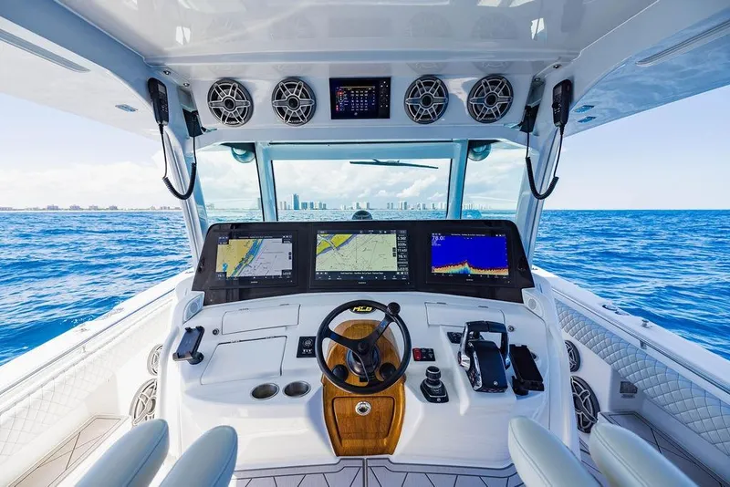 Slide: The Image of Helm of 2023 HCB 53 Suenos boat with advanced navigation displays on open sea. - 70