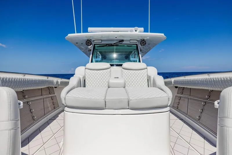 Slide: The Image of 2023 HCB 53 Suenos luxury yacht interior with plush seating and ocean backdrop. - 74