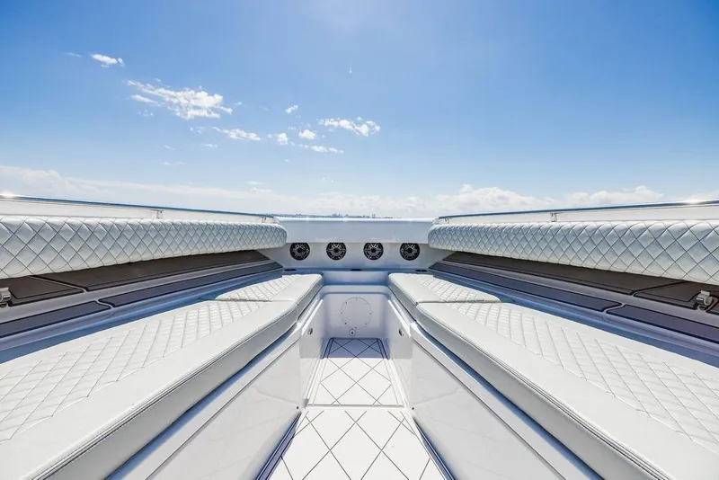 Slide: The Image of Luxurious seating on the 2023 HCB 53 Suenos boat under a clear blue sky. - 75