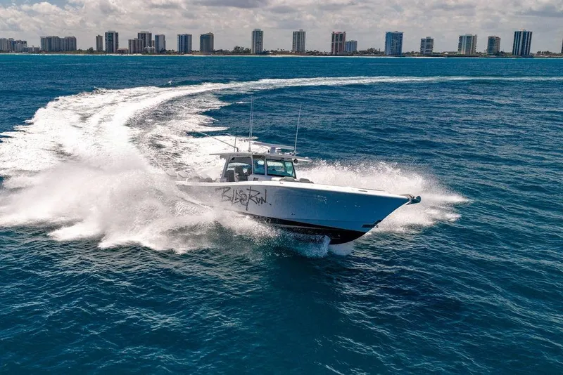 Slide: The Image of 2023 HCB 53 Suenos boat cruising on ocean near city skyline. - 8