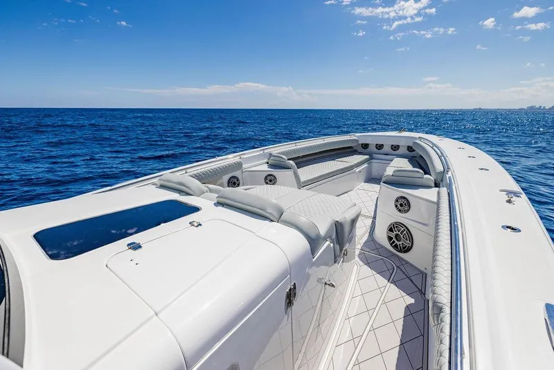 Slide: The Image of 2023 HCB 53 Suenos luxury boat on open ocean, featuring sleek design and spacious seating. - 81