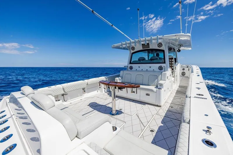 Slide: The Image of 2023 HCB 53 Suenos luxury boat cruising on open ocean under clear blue sky. - 85