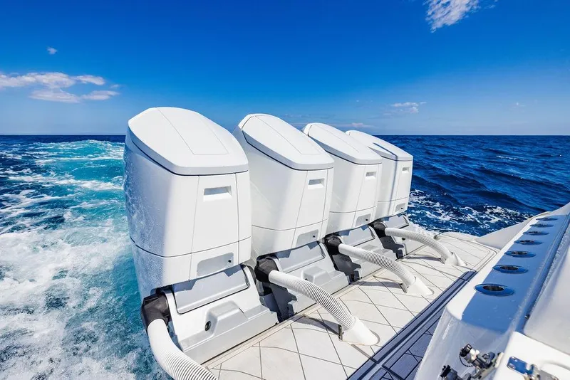 Slide: The Image of Four powerful outboard engines on a 2023 HCB 53 Suenos boat cruising through the ocean. - 88