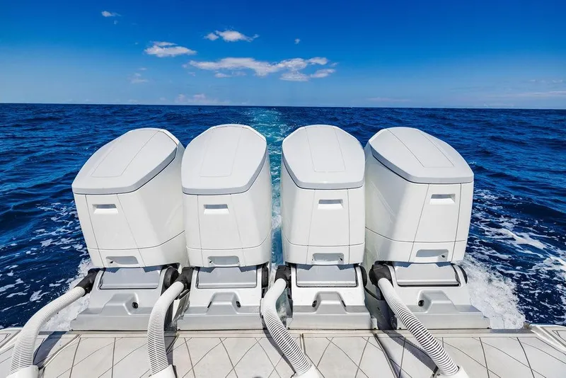 Slide: The Image of Four powerful outboard engines on a 2023 HCB 53 Suenos boat cruising in open ocean. - 89