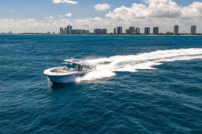 Slide: The Image of 2023 HCB 53 Suenos boat cruising on ocean near city skyline. - 9