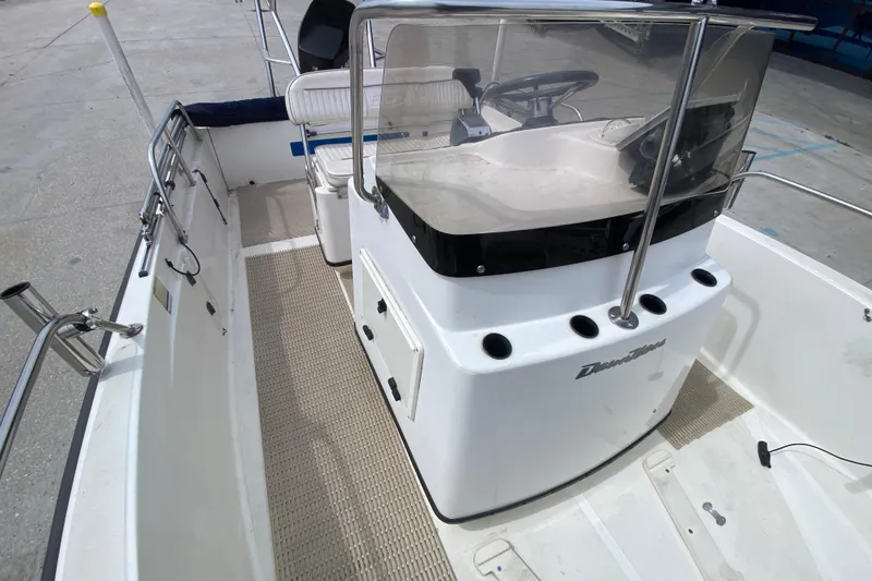 Slide: The Image of 2000 Boston Whaler Dauntless 18 boat interior with steering console and seating. - 12