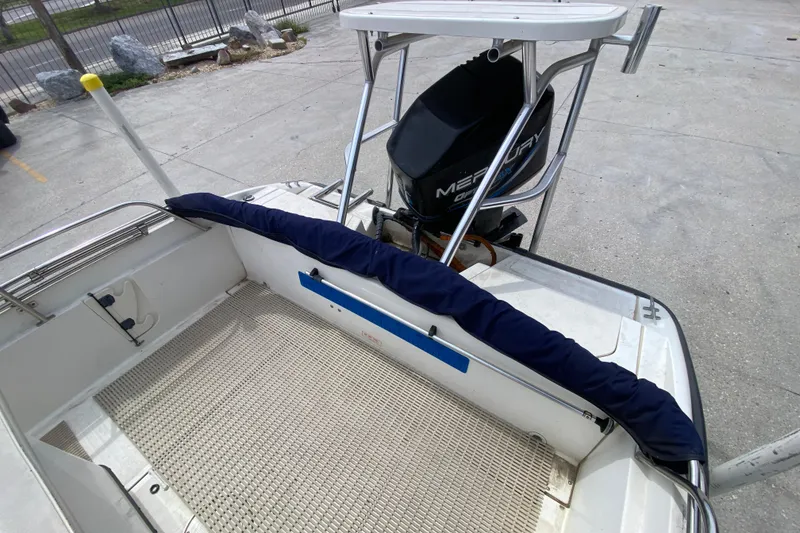 Slide: The Image of Boston Whaler Dauntless 18 boat, 2000 model, with Mercury outboard motor, docked on concrete. - 15