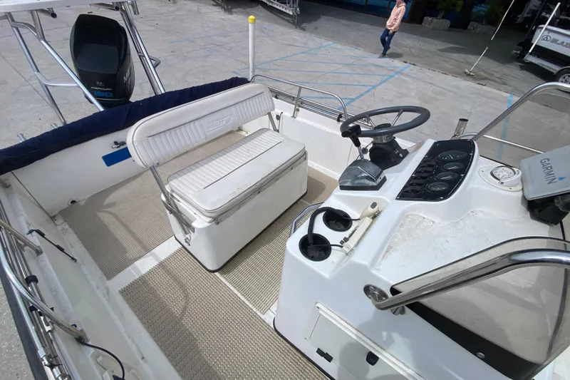Slide: The Image of Boston Whaler Dauntless 18 boat interior, featuring helm, seating, and controls, year 2000 model. - 16