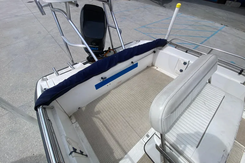 Slide: The Image of Boston Whaler Dauntless 18 boat interior, featuring seating and Mercury outboard motor, 2000 model. - 17