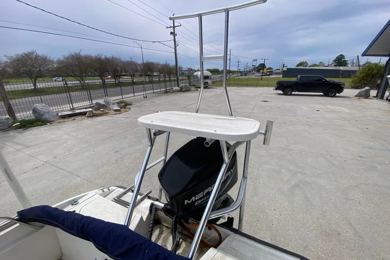Slide: The Image of Boston Whaler Dauntless 18 boat, 2000 model, with Mercury engine in a parking lot. - 21