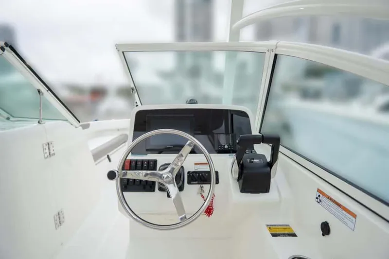 Slide: The Image of Manufacturer Provided Image: 2026 World Cat 230 DC boat dashboard with steering wheel and controls. - 4