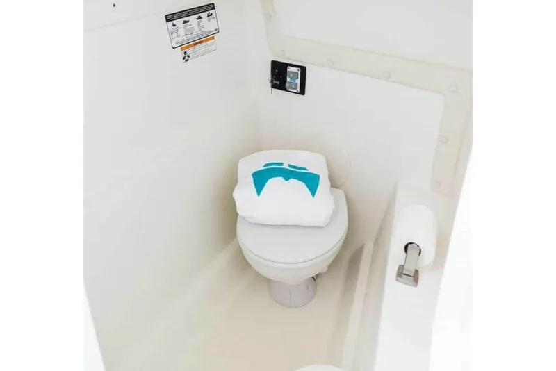 Slide: The Image of Manufacturer Provided Image: 2026 World Cat 230 DC boat interior with compact marine toilet. - 7