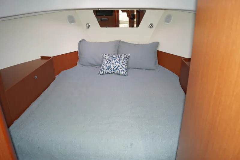 Slide: The Image of 2014 Beneteau Swift Trawler 34 cabin with cozy bed and decorative pillow. - 11