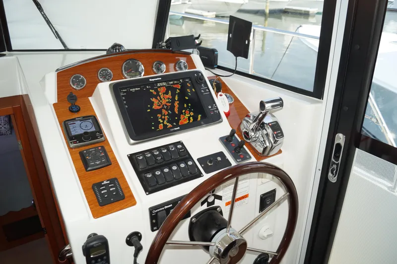 Slide: The Image of 2014 Beneteau Swift Trawler 34 helm with navigation controls and steering wheel. - 14