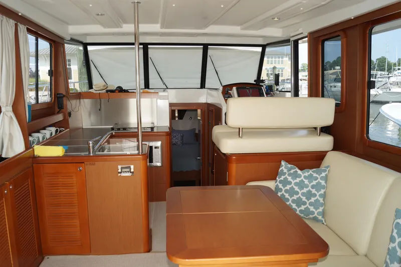 Slide: The Image of Interior of 2014 Beneteau Swift Trawler 34 with kitchen and seating area. - 17