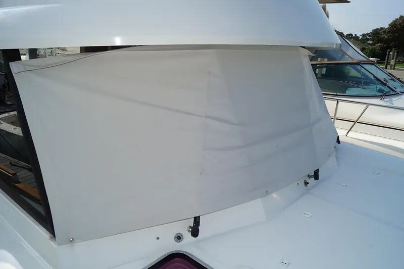 Slide: The Image of 2014 Beneteau Swift Trawler 34 with covered windshield, docked outdoors. - 22