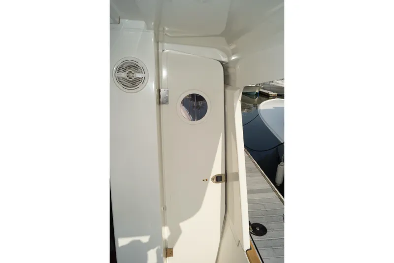 Slide: The Image of 2014 Beneteau Swift Trawler 34 exterior door with porthole, dockside view. - 23