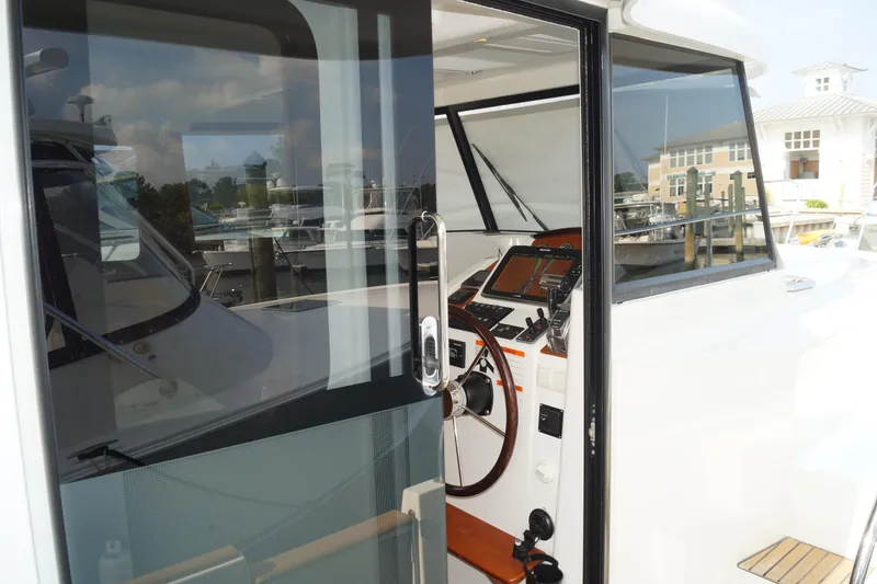 Slide: The Image of 2014 Beneteau Swift Trawler 34 helm station with modern navigation equipment. - 25