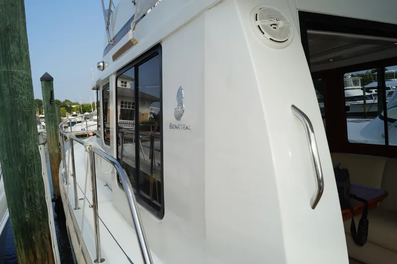 Slide: The Image of 2014 Beneteau Swift Trawler 34 docked at marina, showcasing sleek design and logo. - 26