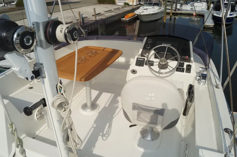 Slide: The Image of 2014 Beneteau Swift Trawler 34 helm with steering wheel and navigation controls. - 27