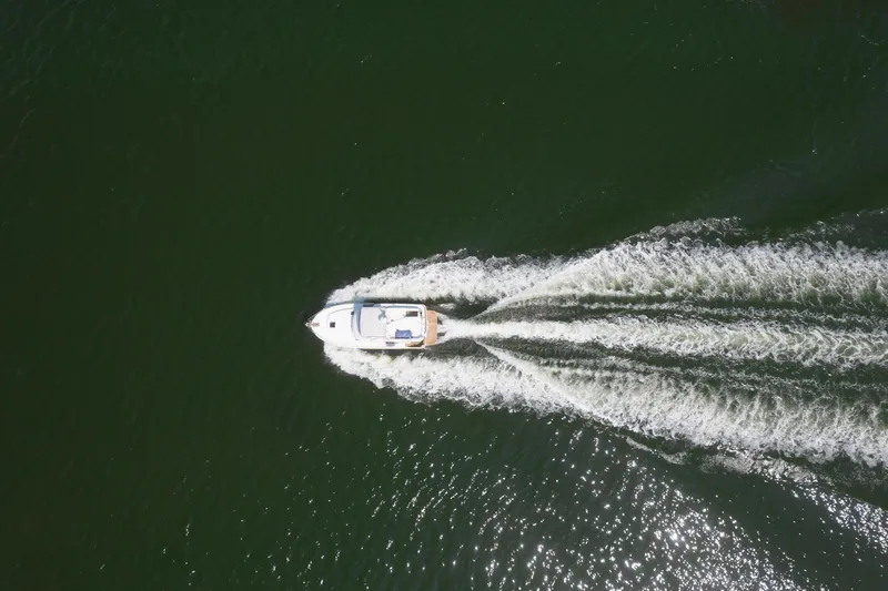 Slide: The Image of Aerial view of 2014 Beneteau Swift Trawler 34 cruising on open water. - 6