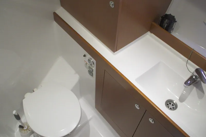 Slide: The Image of Bathroom interior of 2014 Beneteau Swift Trawler 34, featuring sink and toilet. - 7