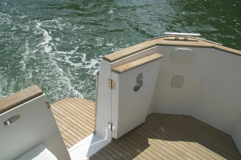 Slide: The Image of 2014 Beneteau Swift Trawler 34 deck with wooden finish on water. - 8