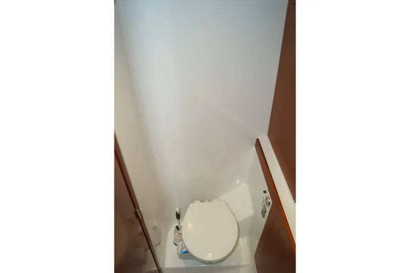 Slide: The Image of Bathroom interior of 2014 Beneteau Swift Trawler 34, featuring compact toilet design. - 9