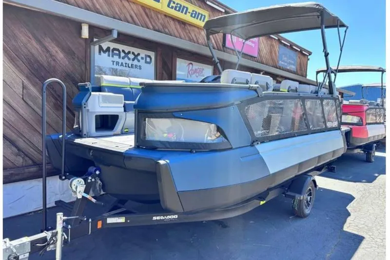 The Image of 2025 Sea-Doo Switch Cruise Limited 21 pontoon boat on trailer, parked outside dealership. - 0
