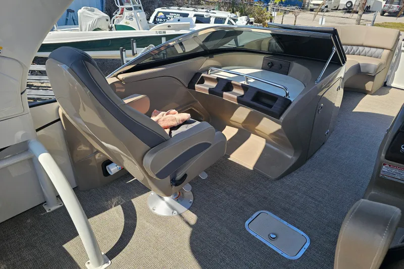 Slide: The Image of 2025 Bennington QX 27 QXSBWA X2 Swingback interior with helm and seating area. - 13