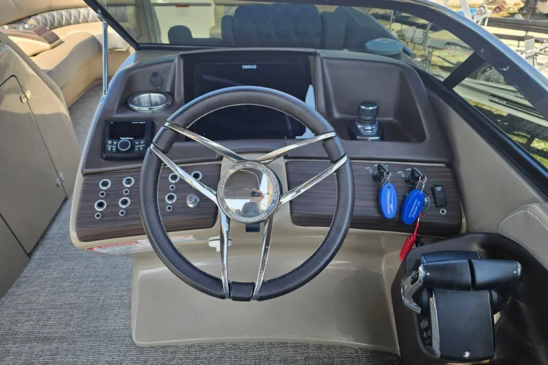 Slide: The Image of 2025 Bennington QX 27 QXSBWA X2 Swingback boat dashboard with steering wheel and controls. - 14