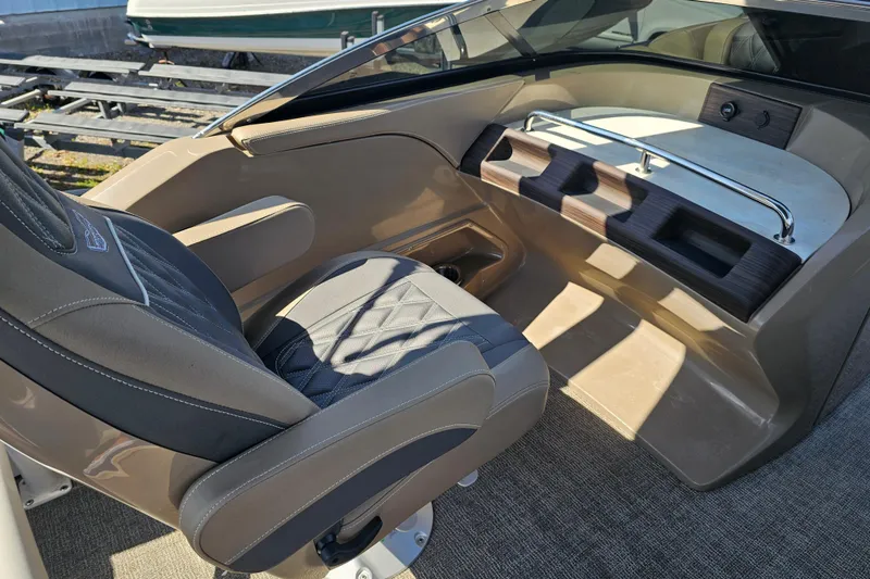 Slide: The Image of 2025 Bennington QX 27 QXSBWA X2 Swingback interior with luxurious seating and sleek design. - 16
