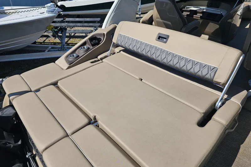 Slide: The Image of 2025 Bennington QX 27 QXSBWA X2 Swingback with luxurious tan seating and cup holders. - 18