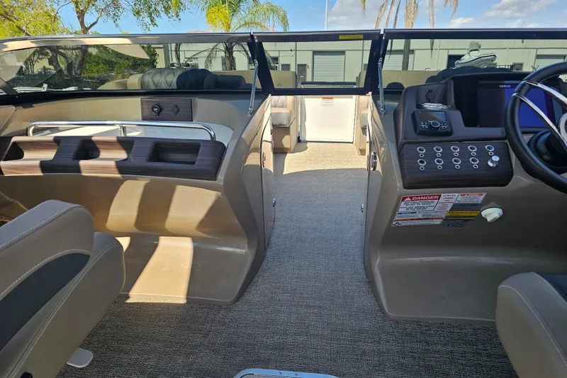 Slide: The Image of 2025 Bennington QX 27 QXSBWA X2 Swingback interior with modern dashboard and seating. - 20
