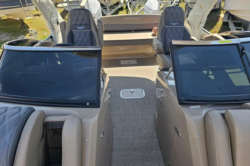 Slide: The Image of 2025 Bennington QX 27 QXSBWA X2 Swingback interior with luxurious seating and sleek design. - 28