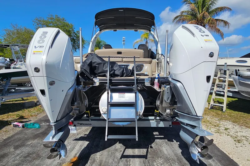 Slide: The Image of 2025 Bennington QX 27 QXSBWA X2 Swingback with dual 300 V8 engines, docked outdoors. - 3