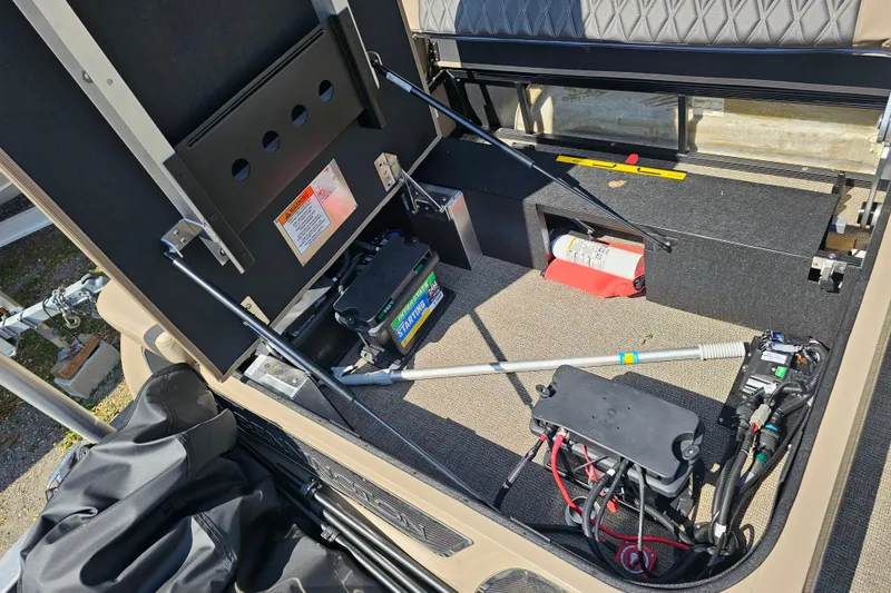 Slide: The Image of Interior view of 2025 Bennington QX 27 QXSBWA X2 Swingback, showcasing battery and storage compartments. - 32