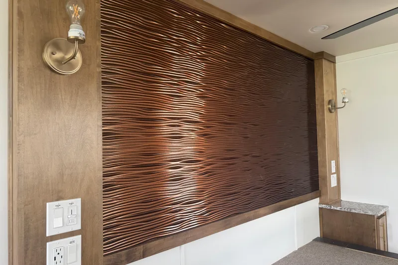 Slide: The Image of Textured wall panel in Sumerset Voyager 2026 interior, featuring modern lighting and wood accents. - 15