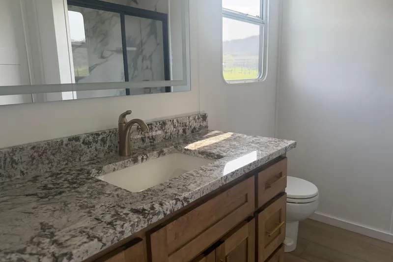 Slide: The Image of Modern bathroom in 2026 Sumerset Voyager with granite countertop and sleek fixtures. - 18