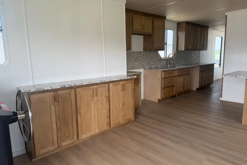 Slide: The Image of Modern kitchen interior in 2026 Sumerset Voyager, featuring wooden cabinets and marble countertops. - 2