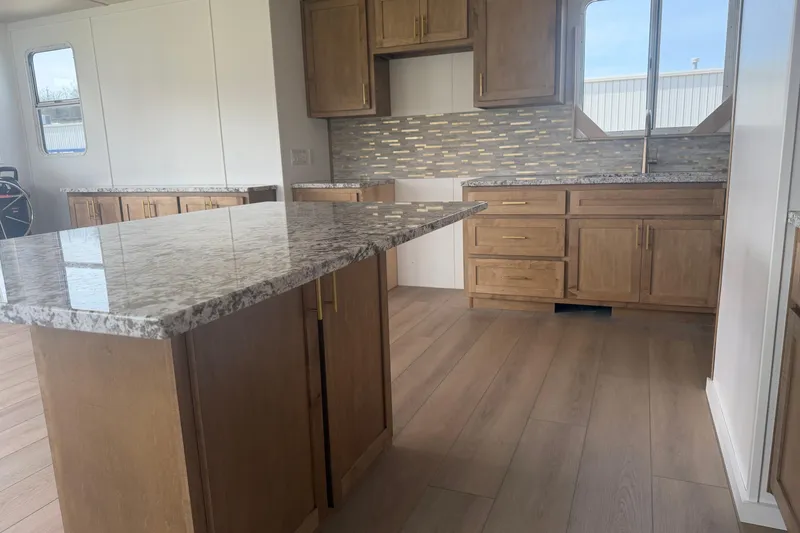 Slide: The Image of Modern kitchen in 2026 Sumerset Voyager with granite countertops and wooden cabinets. - 7