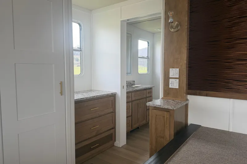 Slide: The Image of Modern interior of 2026 Sumerset Voyager with wooden cabinetry and granite countertops. - 9