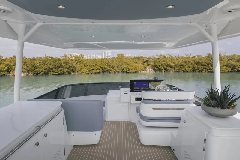 Slide: The Image of Luxurious 2025 Cruisers Yachts 57 Fly interior with modern helm and scenic water view. - 16